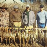 Hunters posing with pheasants they shot