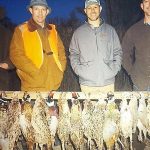 Hunters posing with pheasants they shot