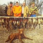 Hunters posing with pheasants they shot