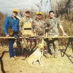 Hunters posing with pheasants they shot