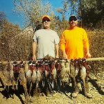 Hunters posing with pheasants they shot