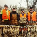 Hunters posing with pheasants they shot