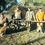 Hunters posing with pheasants they shot