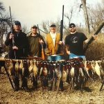 Hunters posing with pheasants they shot